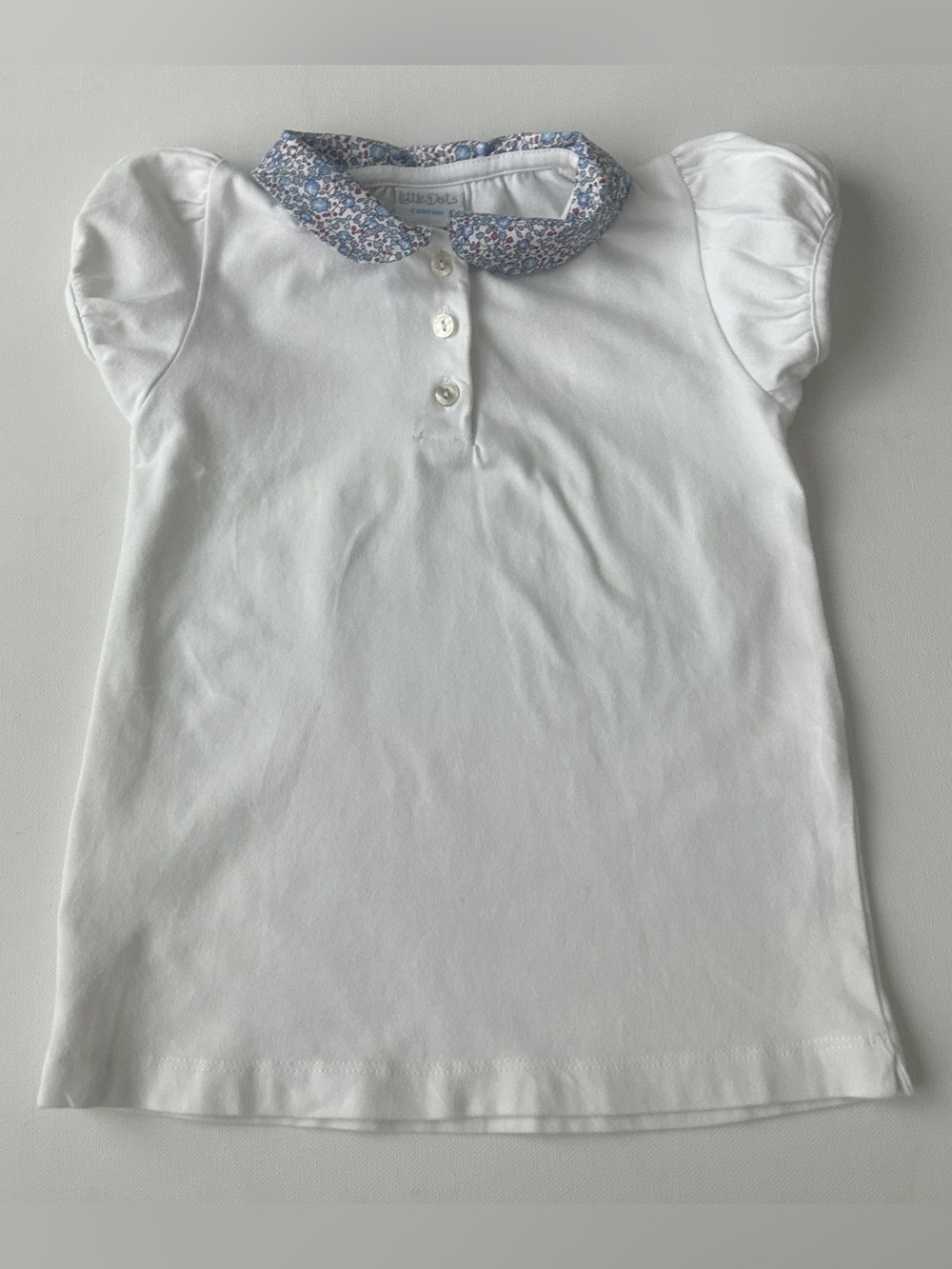 Little Dots girl’s polo shirt a distinct floral Liberty print collar.  Size 4T.